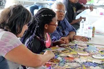 A mosaic mandala being created during a community workshop.