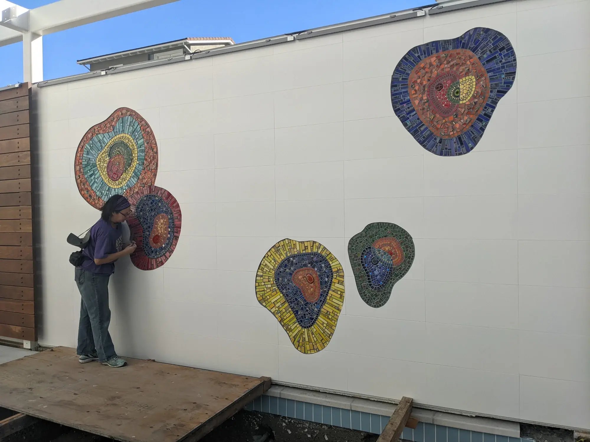 Instructor Luz putting finishing touches on the completed mosaic.
