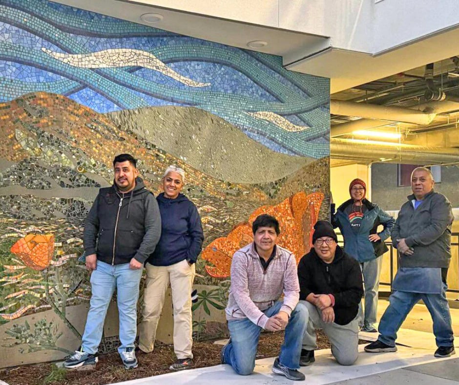 Artists standing in front of the completed mural.
