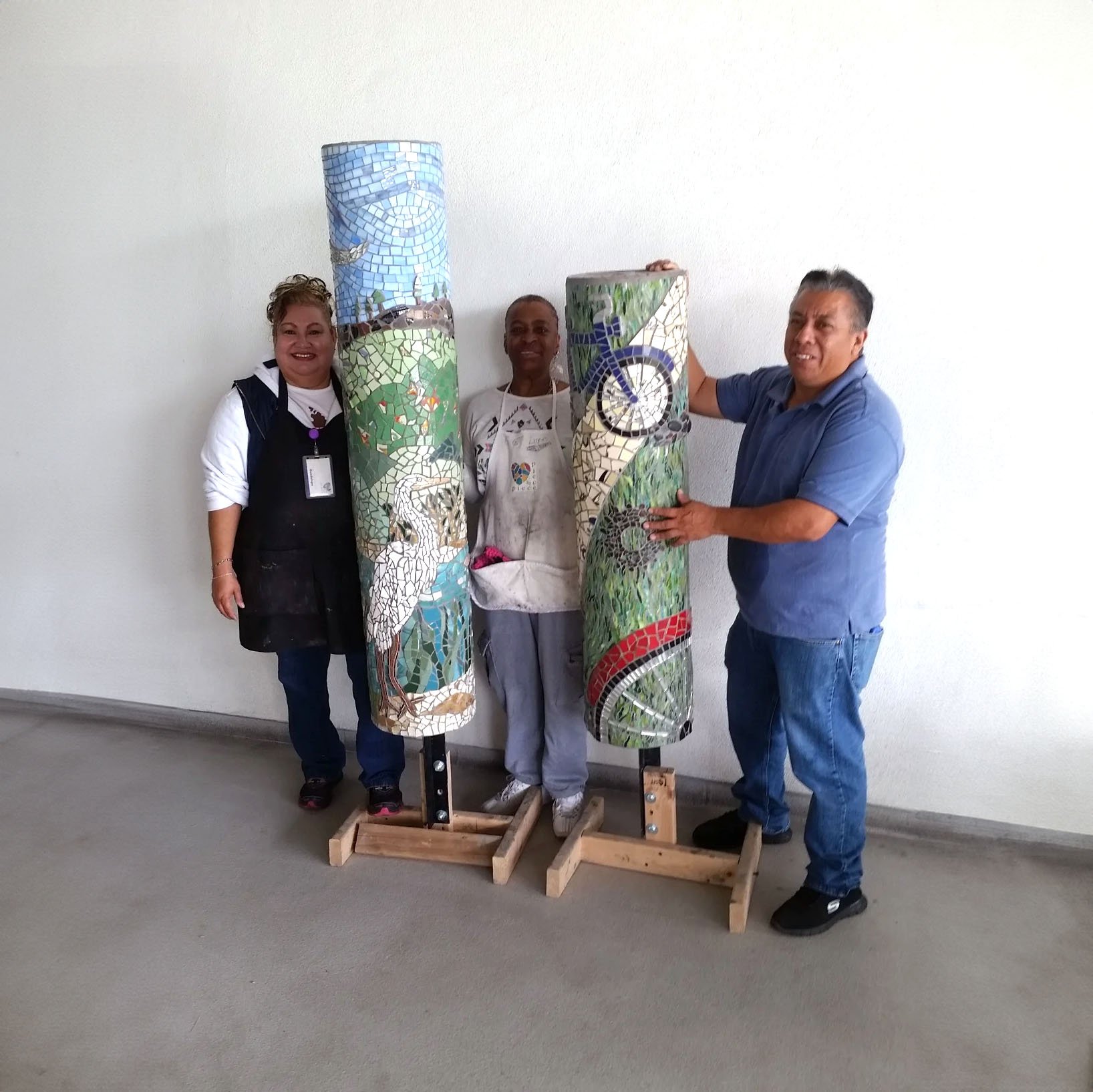 Artists standing between the completed Native Flora and Fauna Pilars.
